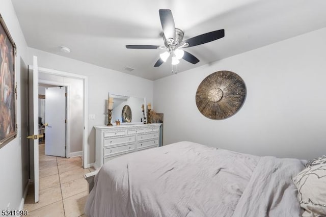 bedroom with light tile patterned flooring, a ceiling fan, and baseboards