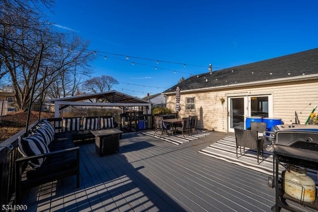 wooden deck featuring outdoor dining area, a gazebo, and an outdoor hangout area