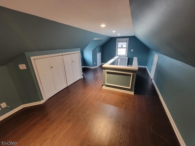 bonus room featuring vaulted ceiling, dark wood-type flooring, recessed lighting, and baseboards