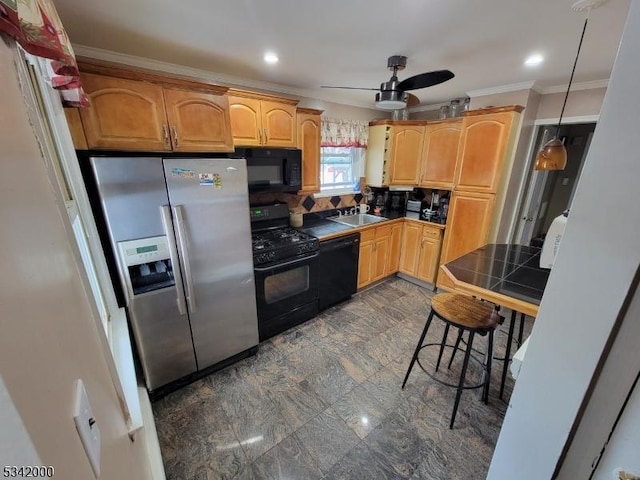 kitchen featuring tile counters, ornamental molding, a sink, ceiling fan, and black appliances