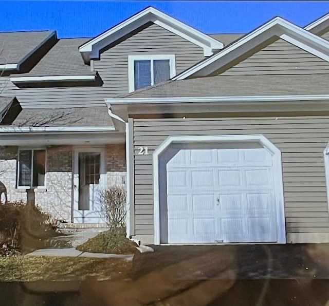 view of front of home featuring an attached garage and aphalt driveway