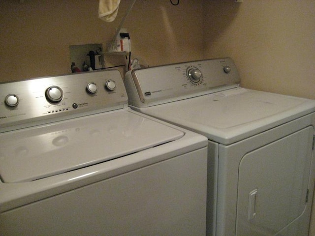 washroom with washing machine and clothes dryer