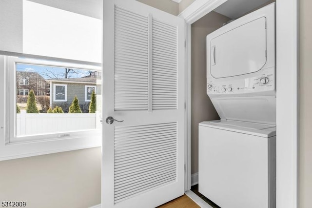 laundry room with stacked washer / dryer and laundry area