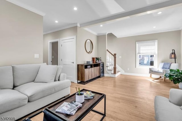 living area featuring light wood-style flooring, recessed lighting, baseboards, ornamental molding, and stairway