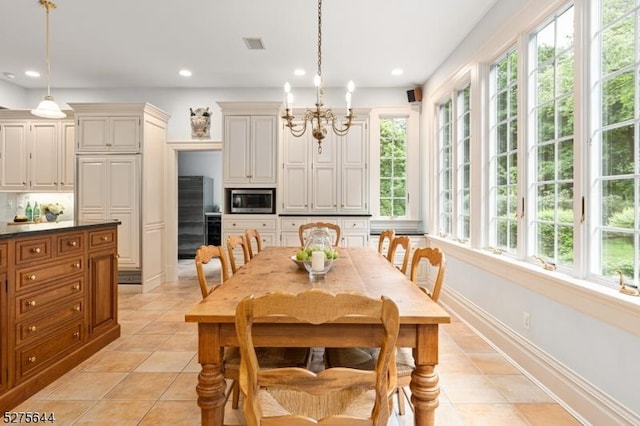 dining room featuring light tile patterned floors, recessed lighting, and an inviting chandelier