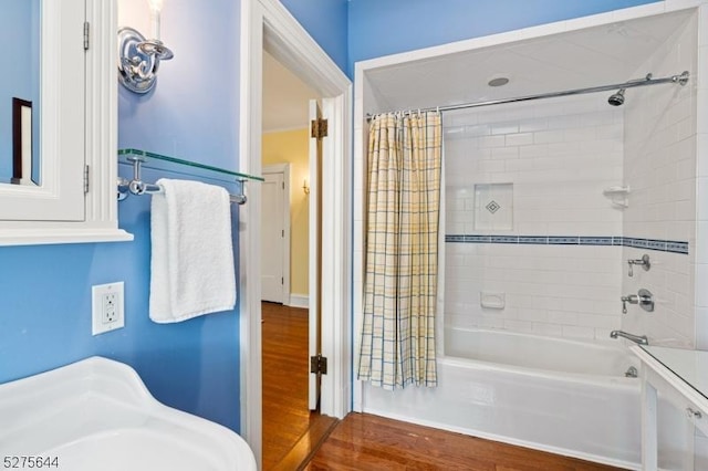 full bathroom featuring a sink, shower / tub combo with curtain, and wood finished floors