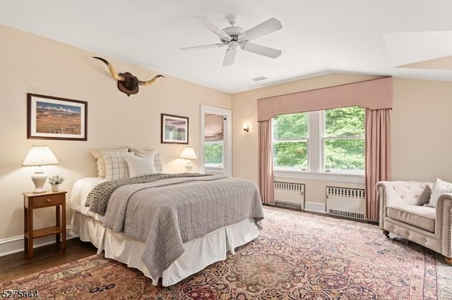 bedroom featuring radiator, ceiling fan, baseboards, and wood finished floors