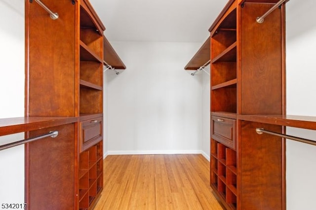 spacious closet featuring light wood finished floors