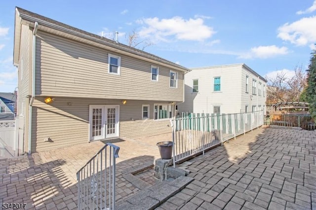 back of property featuring french doors, a patio area, and fence