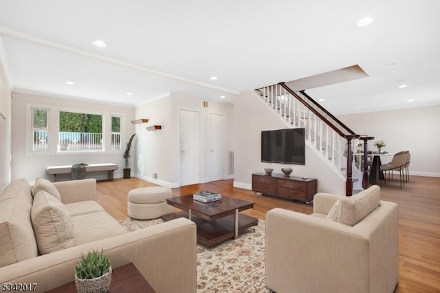 living area featuring light wood-style flooring, recessed lighting, stairway, and baseboards