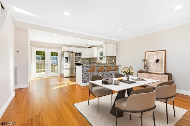 dining area featuring light wood finished floors, baseboards, ornamental molding, french doors, and recessed lighting