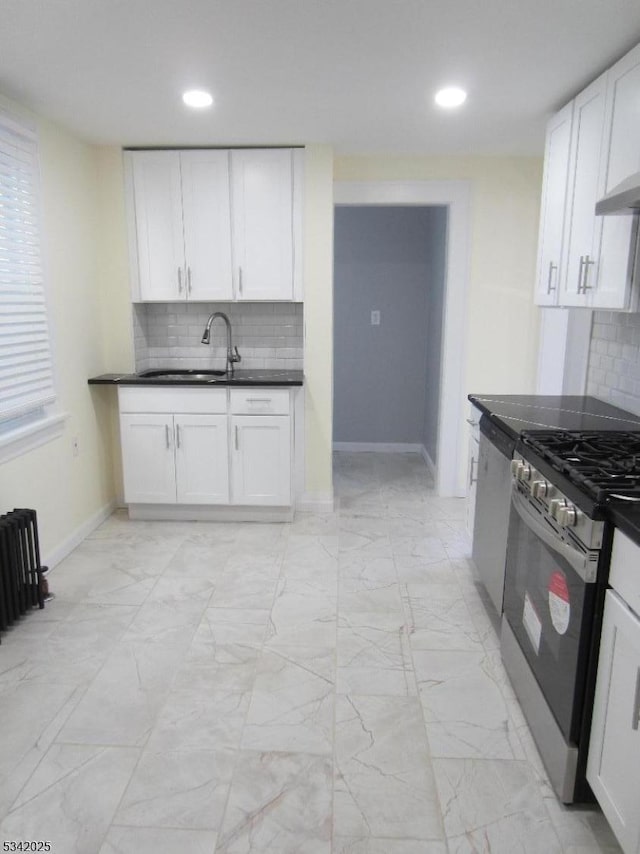 kitchen with stainless steel appliances, marble finish floor, white cabinets, and a sink