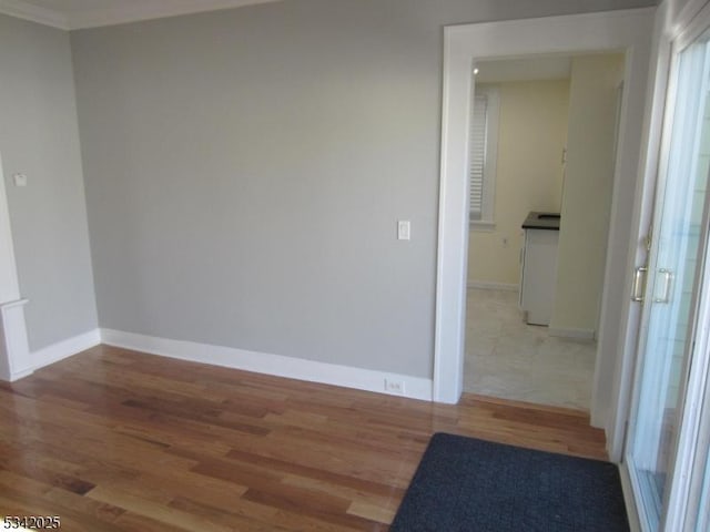 empty room with wood finished floors and baseboards