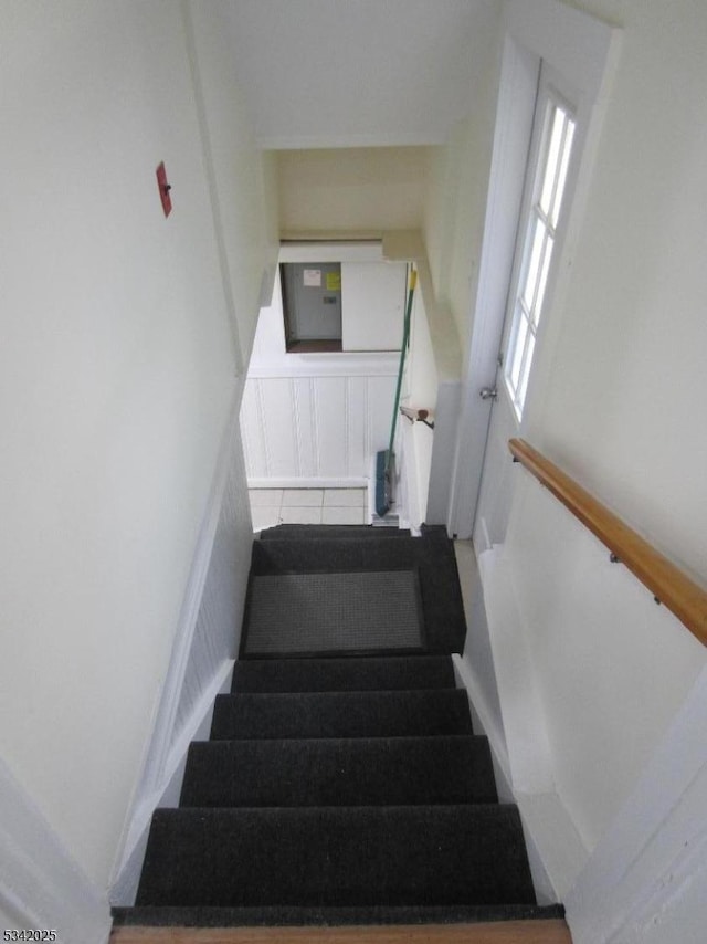 staircase featuring tile patterned flooring