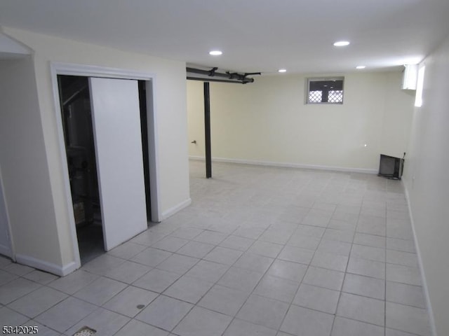 basement with recessed lighting, light tile patterned flooring, and baseboards