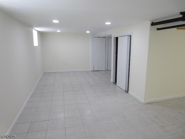 basement featuring baseboards and recessed lighting