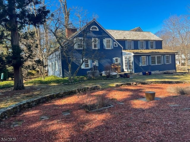 rear view of property featuring french doors