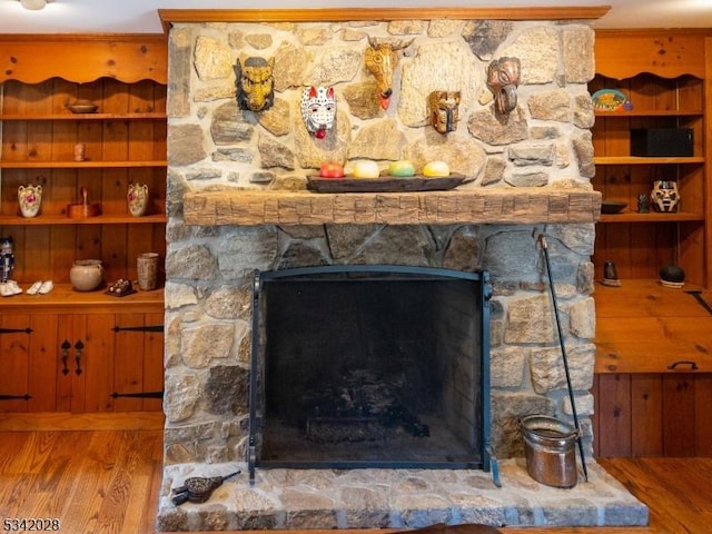 interior details with wood finished floors and a fireplace