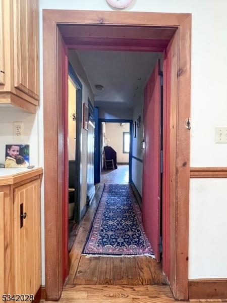 corridor featuring wood finished floors