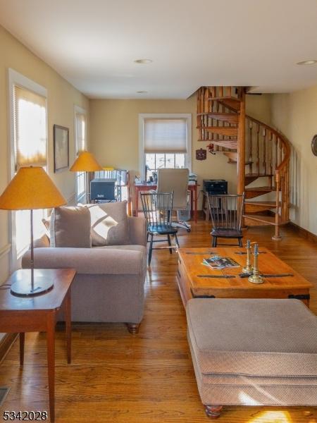 living area featuring wood finished floors and stairs