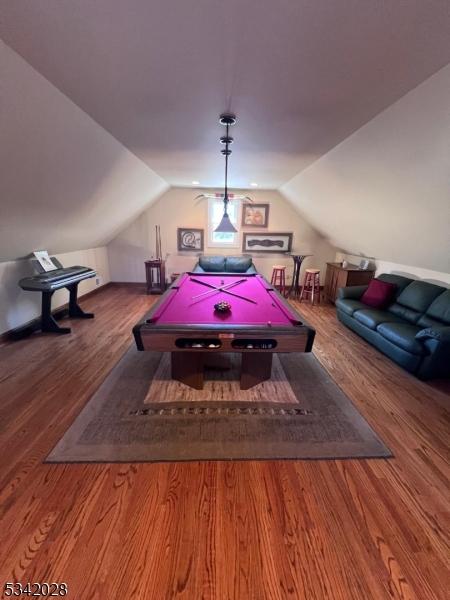 rec room featuring billiards, wood finished floors, and vaulted ceiling