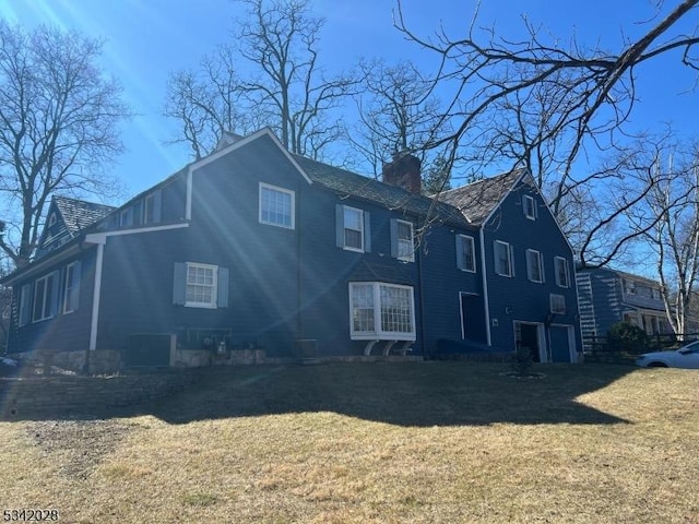 exterior space with a yard and a chimney