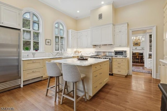 29 Kitchell Rd, Morris Twp, NJ 07960 - kitchen with high end appliances, a center island, a high ceiling, wood finished floors, and a kitchen bar
