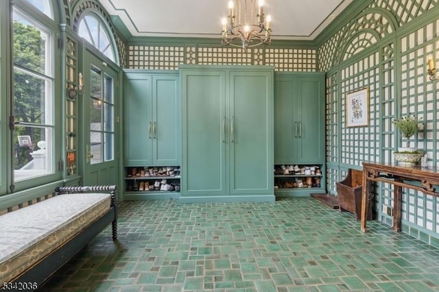 29 Kitchell Rd, Morris Twp, NJ 07960 - mudroom with brick patterned flooring, a chandelier, crown molding, and a decorative wall
