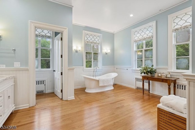 29 Kitchell Rd, Morris Twp, NJ 07960 - bathroom featuring radiator heating unit, a wainscoted wall, vanity, a soaking tub, and healthy amount of natural light