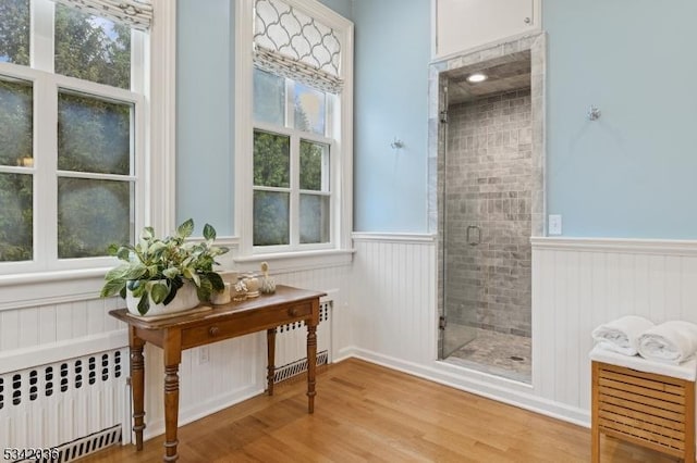 29 Kitchell Rd, Morris Twp, NJ 07960 - bathroom with radiator, wainscoting, a shower stall, and wood finished floors