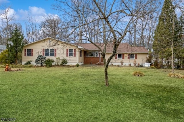 view of front of property with a front yard and brick siding