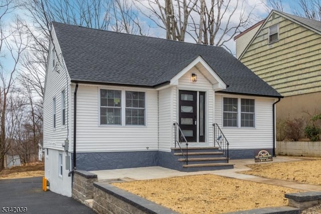 view of front of home with entry steps and roof with shingles