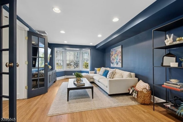 living room with visible vents, wood finished floors, and recessed lighting