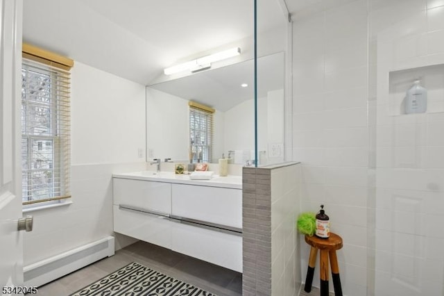 full bathroom featuring vaulted ceiling, plenty of natural light, tile walls, and tile patterned floors