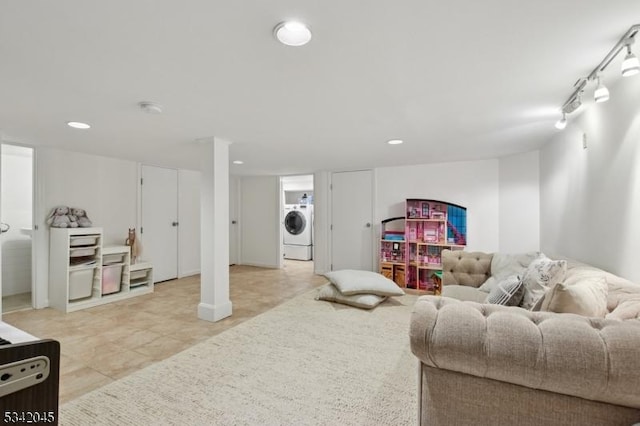 living area with recessed lighting, washer / clothes dryer, and track lighting