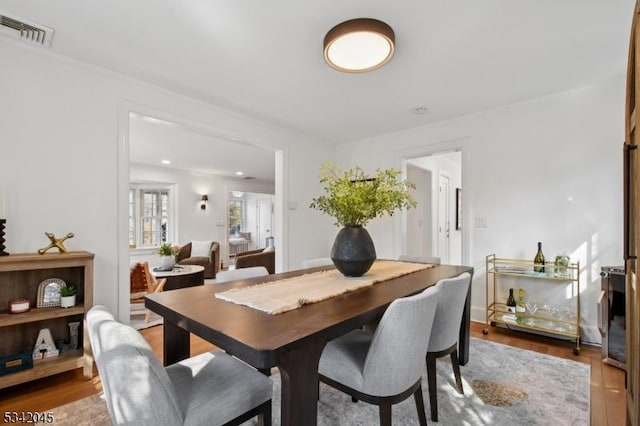 dining space with visible vents and wood finished floors