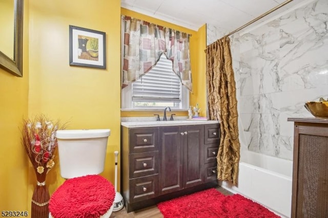 bathroom with toilet, shower / bath combination with curtain, and vanity