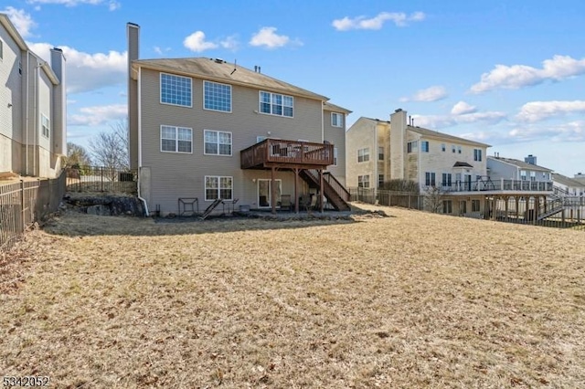 rear view of property with a deck, stairway, and fence private yard