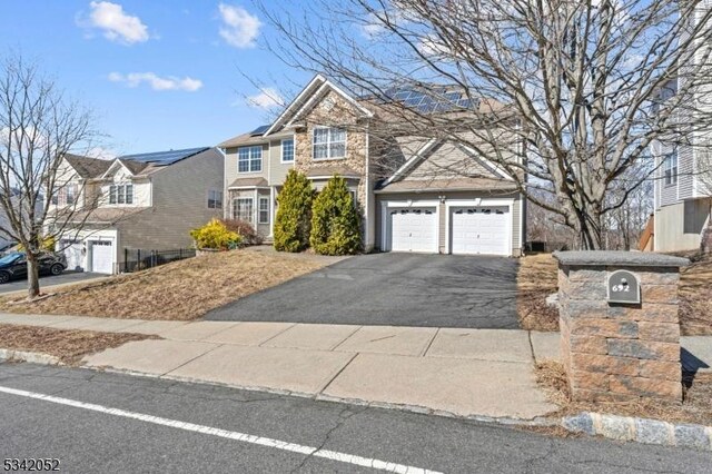 traditional-style house featuring aphalt driveway and a garage