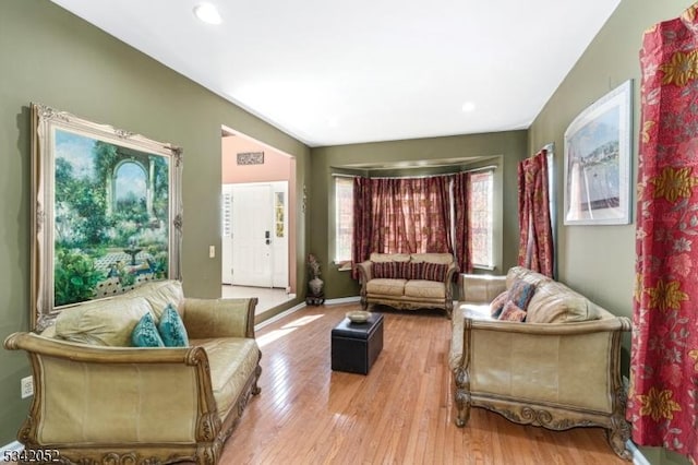living area with recessed lighting, wood finished floors, and baseboards