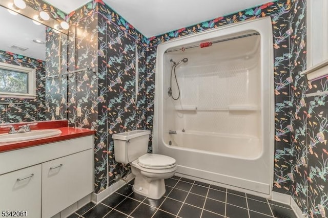 bathroom featuring tile patterned floors, toilet, shower / washtub combination, wallpapered walls, and vanity