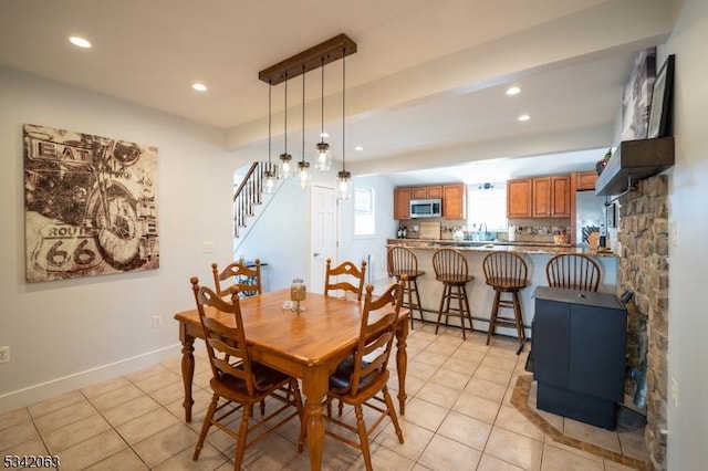 dining room with light tile patterned floors, recessed lighting, baseboards, and a baseboard radiator