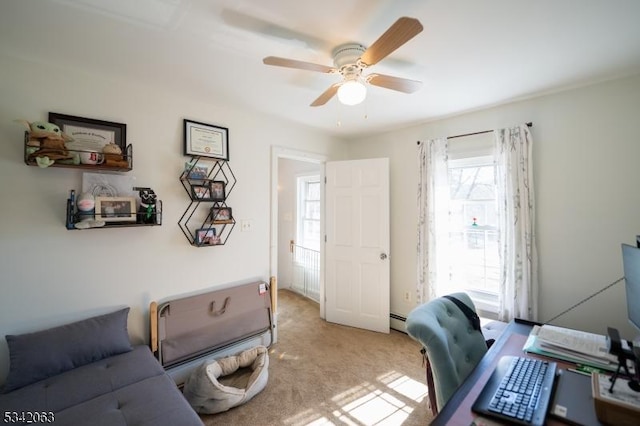 office featuring a ceiling fan, baseboard heating, and carpet flooring