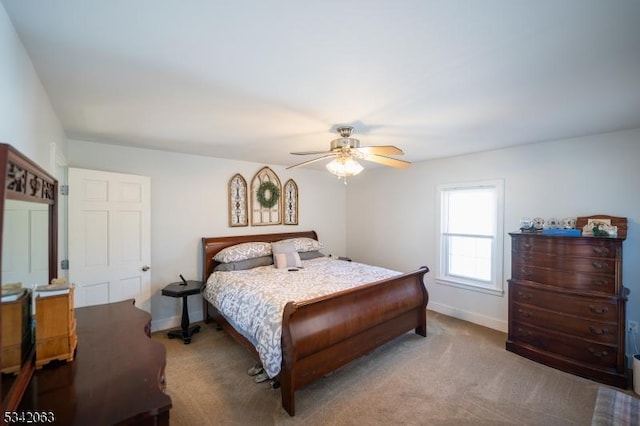 bedroom with ceiling fan, carpet, and baseboards