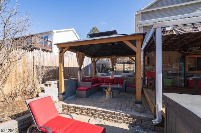 view of patio featuring a gazebo, outdoor lounge area, and fence