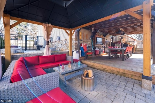 view of patio featuring outdoor dining space, an outdoor living space, a gazebo, and fence