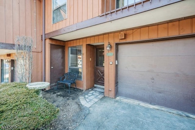 entrance to property with a garage and board and batten siding