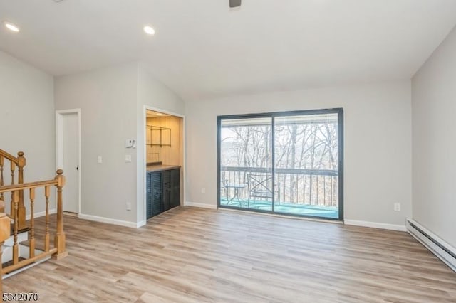 living area featuring stairway, light wood-style flooring, baseboards, and baseboard heating