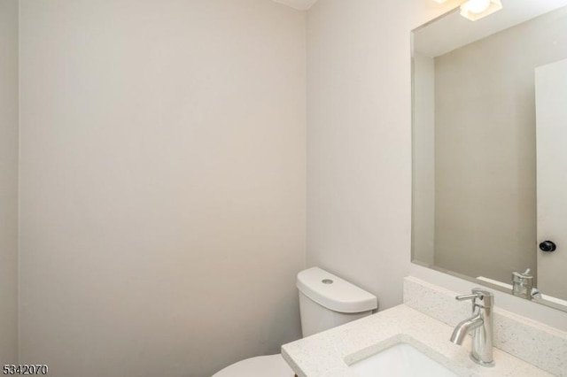 bathroom with toilet and vanity