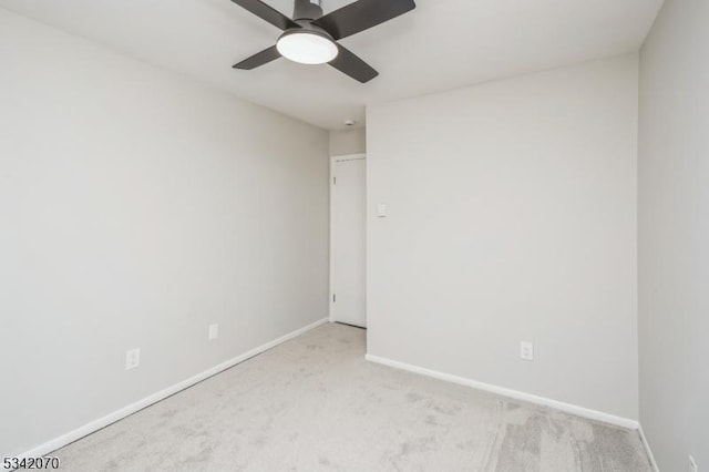 spare room with a ceiling fan, baseboards, and carpet floors